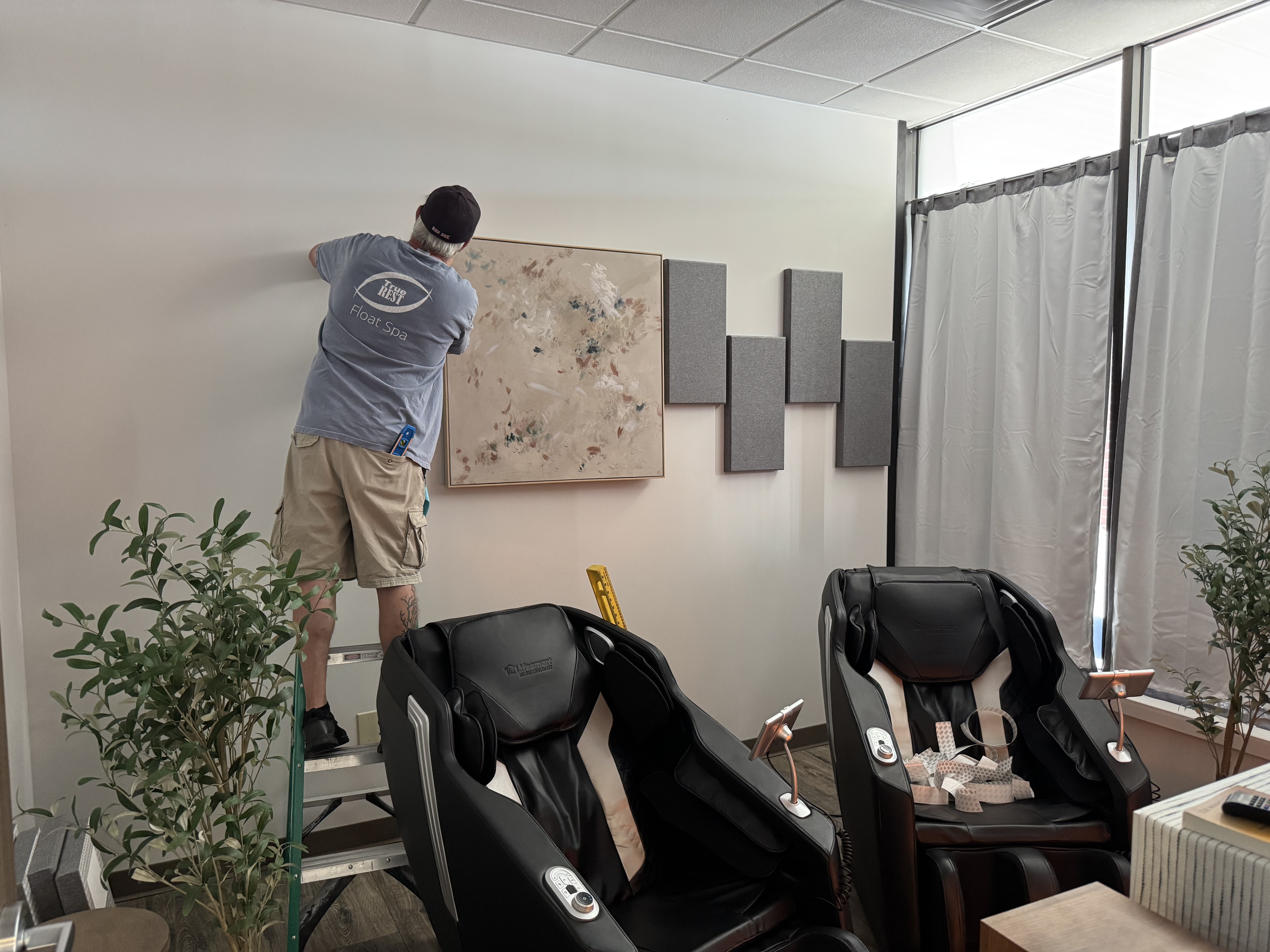 Jeff Myatt installing acoustic panels at True REST Float Spa